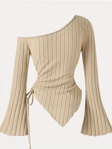 Detailed view of the ribbed knit fabric and elegant asymmetric hem on this bell sleeve top