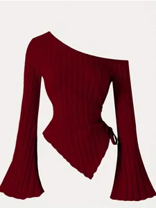 Close-up of elegant burgundy one-shoulder top featuring asymmetrical hem and bell sleeves.