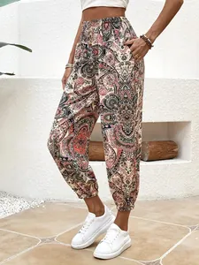 Macro view of bohemian paisley print pants featuring smocked waist and side pockets