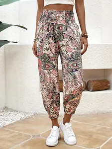 Detail shot of stylish women's bohemian ethnic paisley print trousers in pastel colors