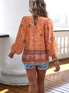Orange Bohemian floral print long-sleeved shirt for women shown from the back view