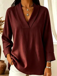 Close-up of a burgundy V-neck shawl collar blouse for women with textured crepe fabric