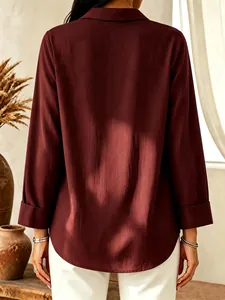 Back view of a elegant burgundy long-sleeved shirt showing lightweight fabric texture