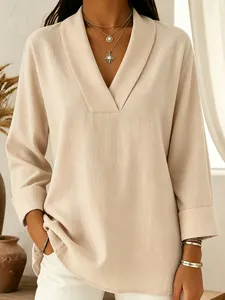 Detail of elegant beige V-neck shawl collar shirt with textured fabric for women