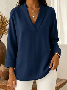 Detailed view of navy blue V-neck shawl collar blouse with elegant fabric texture