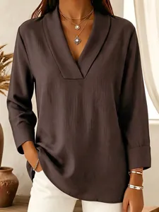 Close-up detail of a dark brown satin shawl collar V-neck blouse with elegant silk texture
