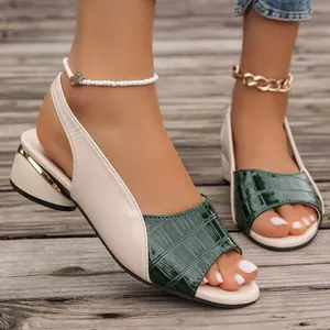 Close-up of color-blocked block heel sandals with green croc-textured peep-toe design