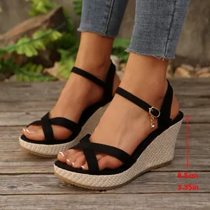 Detailed view of black cross strap wedge sandals with 8.5cm heel height