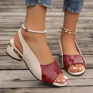 Close-up of peep-toe sandals featuring burgundy croc-embossed texture and block heel