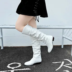Close-up detail of stylish white slouchy mid-calf boots with a comfortable low chunky heel.