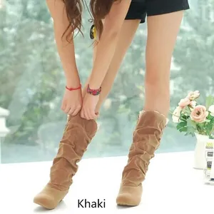 Detailed view of khaki suede mid-calf boots featuring lace trim and slouchy design