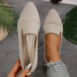 Detailed close-up showing the beige pointed-toe fly-knit flat shoes texture and design