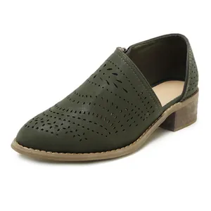 Detailed view of dark green laser-cut ankle boot with block heel and pointed toe
