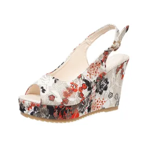 Close-up of stylish floral peep-toe wedge sandals with adjustable slingback buckle