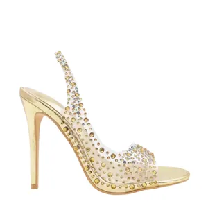 Sandales à talons aiguilles dorées avec ornements en strass sur brides en PVC transparent