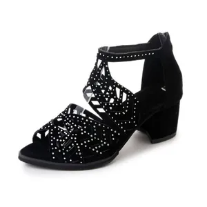 Side view detail of black block heel sandals featuring sparkly rhinestones and cut-out patterns