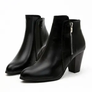 Close-up side view of elegant black chunky heel ankle boots with metal zipper detail