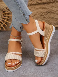 Detailed close-up view of stylish beige braided wedge sandals with platform soles