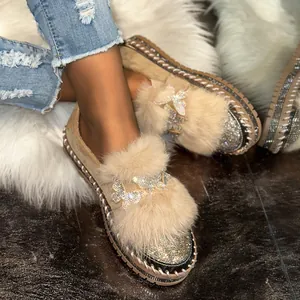 Detail view of women's thick-sole loafers featuring plush fur and butterfly rhinestones.