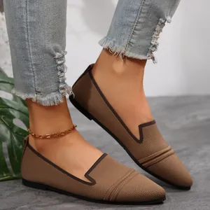 Detailed view of stylish brown knit pointed-toe flats featuring breathable mesh fabric
