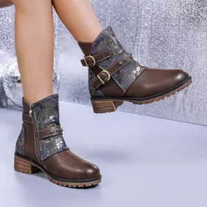 Detailed view of the intricate floral print splicing and metal buckle straps on brown Western boots