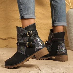 Side view of women's western ankle boots featuring floral print and dual buckles.