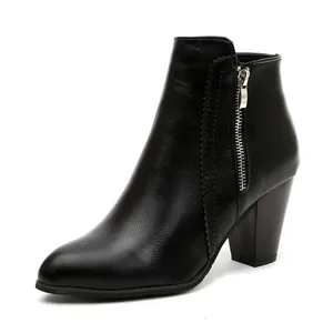 Elegant black faux leather ankle boot featuring a chunky heel and side zipper detail.