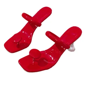 Vibrant red thong sandals with square toe and transparent wine glass heel