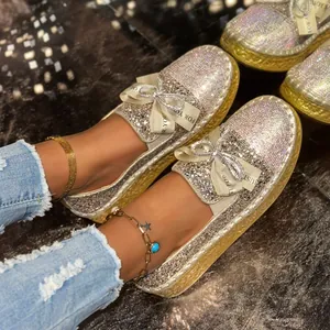 Close-up of sparkling rhinestone slip-on loafers for women featuring a chic French bow detail