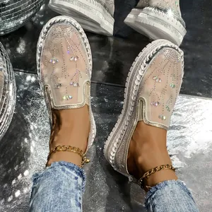 Detailed view of sparkling rhinestone-embellished mesh loafers with thick white soles for women.