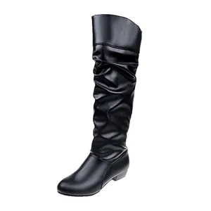 Side view of black slouchy knee-high boots with round toe and low flat heel design