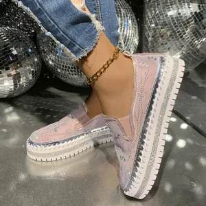 Close-up detail view of pink rhinestone platform loafers with glitter accents and mesh fabric