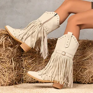 Western cowboy boots for women featuring fringe, studs, and a pointed toe with block heels