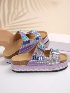 Side view of purple platform slippers with double buckles and sparkling rhinestones