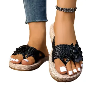 Elegant black woven thong sandals for women featuring a large decorative flower