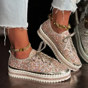 Nahaufnahme von Damen-Sneakern mit Glitzer-Plateau und funkelnden Strassdetails.