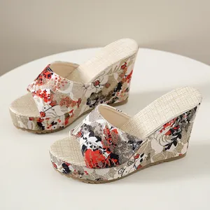 Detailed view of floral print wedge sandals with elegant high heel and peep toe design