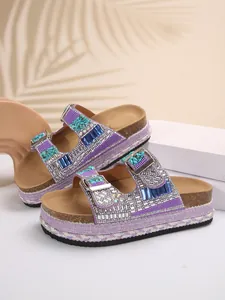 Luxurious purple platform slippers featuring ornate rhinestone beads and double buckle detail