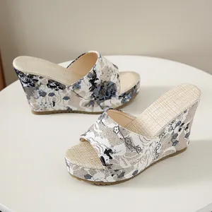 Close-up side view of floral print wedge heel sandals featuring a vintage peep toe design