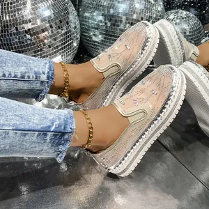 Glamorous rhinestone mesh loafers with thick white platform soles shown in a disco setting.