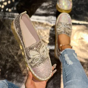 Detailed close-up of sparkling rhinestone women's loafers with elegant ribbon bow