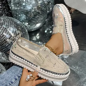 Detail of women's thick-soled loafers featuring sparkling rhinestones and mesh design