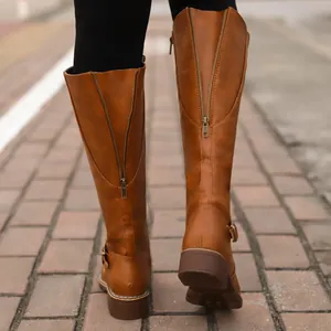 Detailed back view of stylish brown knee-high riding boots with gold zipper and buckle accents