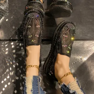 Detailed view of black mesh loafers with colorful rhinestones and thick platform soles