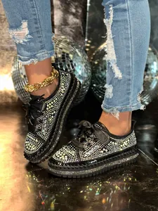 Detailed view of fashionable sparkly multi-color rhinestone platform loafers for women.