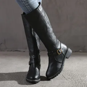 Detail of black round-toe knee-high knight boots with decorative buckle straps