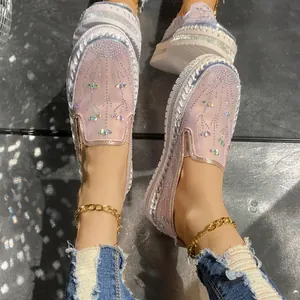 Detail shot of stylish pink rhinestone mesh loafers with thick platform soles and crystals.