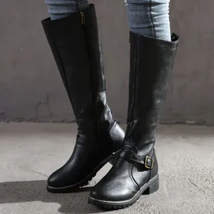 Detail view of black knee-high knight boots with side zipper and buckle