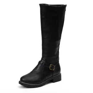 Close-up of black knee-high knight boots with buckle detail and flat block heel