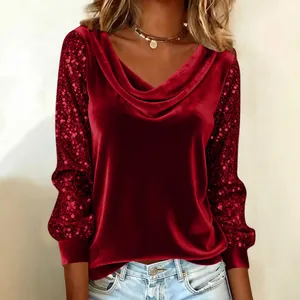 Detailed view of red velvet top featuring a draped cowl neck and sequined sleeves